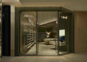 inside Aesop Red Sea Mall, the same tension of forms plays out as two volumes—one linear, one fluid—spill into each other